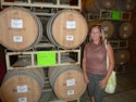 Diane next to some barrels